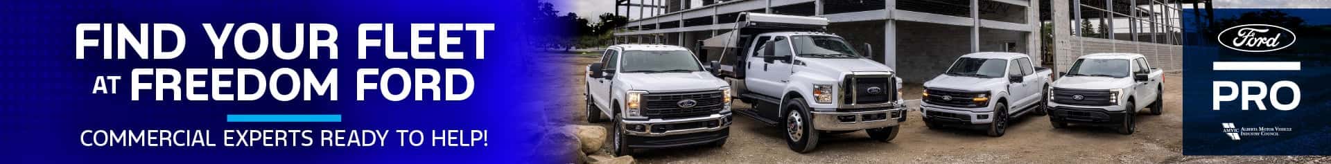 Lineup of Ford commercial trucks and work vehicles parked in front of a steel-frame construction site, with the text “Find Your Fleet at Freedom Ford – Commercial Experts Ready to Help!”